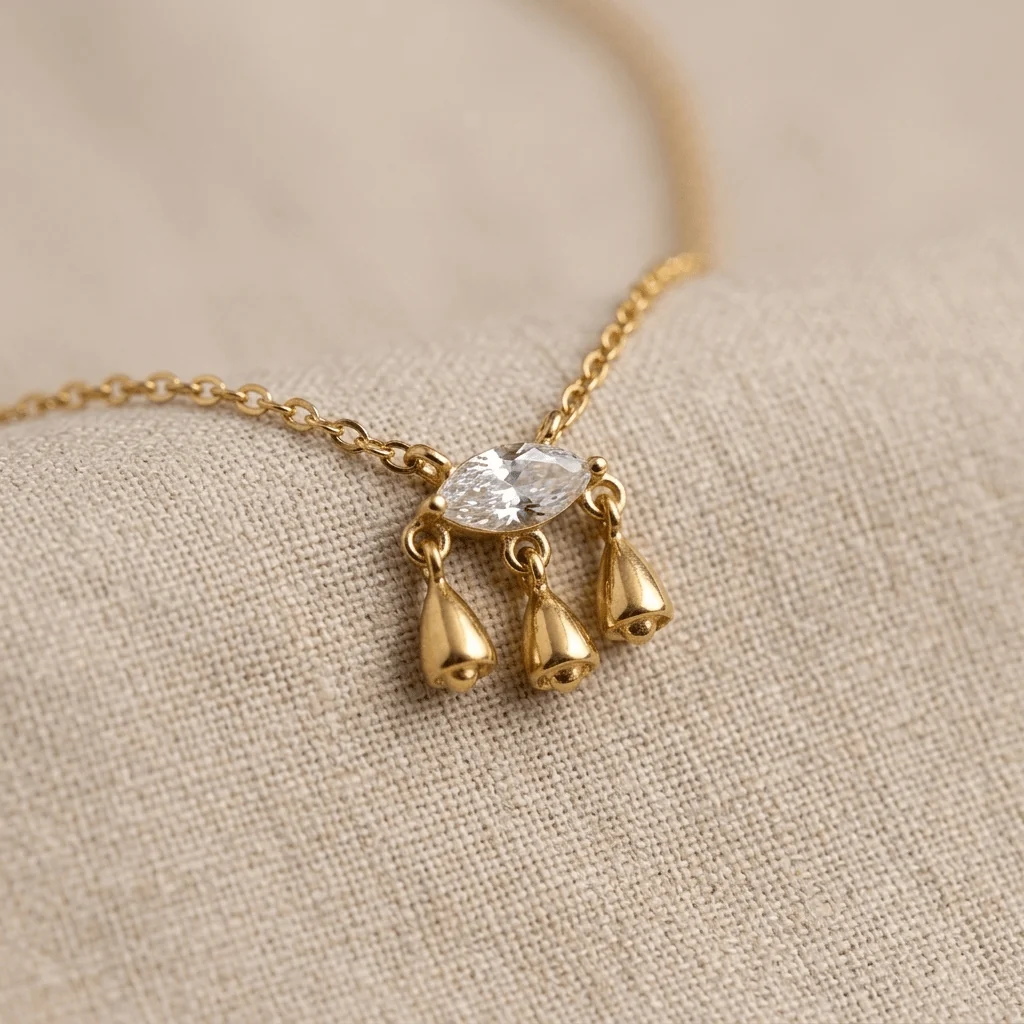 Aurelia Marquise Teardrop Pendant Necklace with a clear marquise stone and three gold-tone drop charms