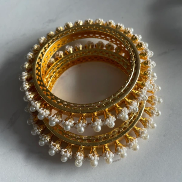 Meher Pearl Bloom gold-tone bangles with white pearl floral detailing