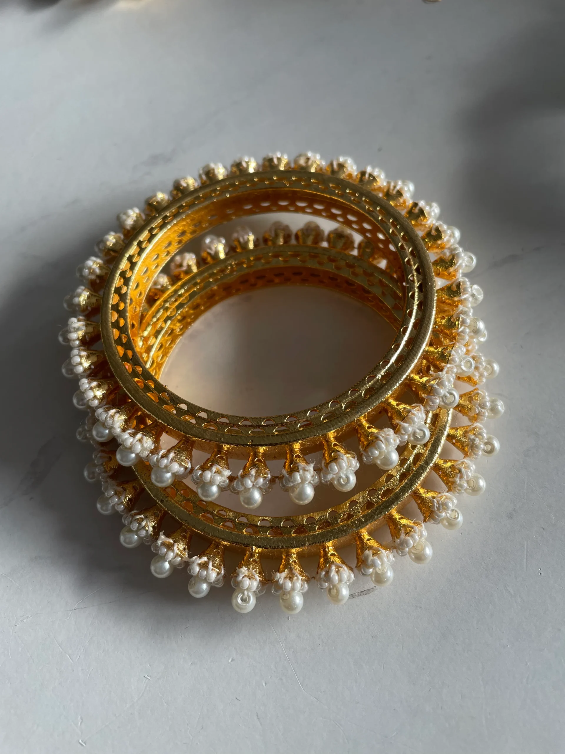 Meher Pearl Bloom gold-tone bangles with white pearl floral detailing